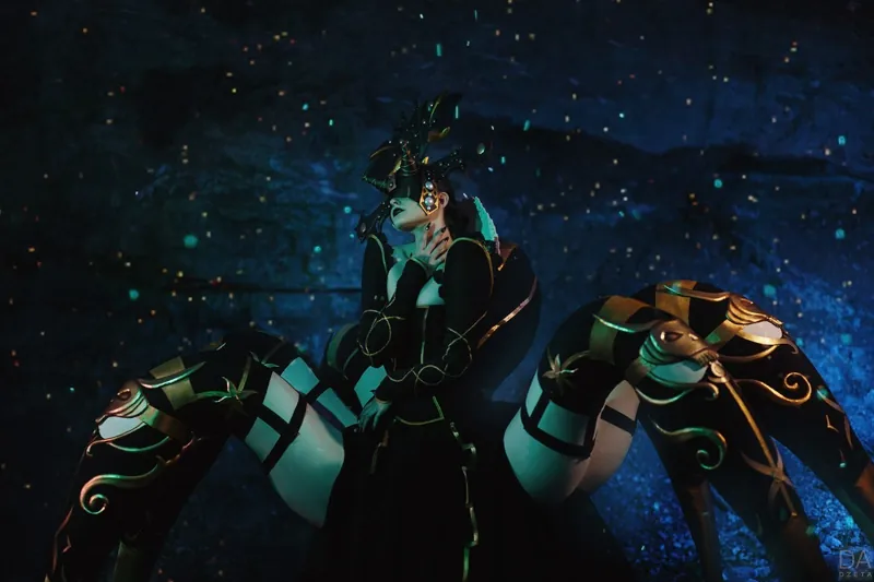 An anthro spider. A green-skinned woman's attractive figure sprouts from an expansive spider lower body. She wears black robes and has her eyes covered over with black cloth.