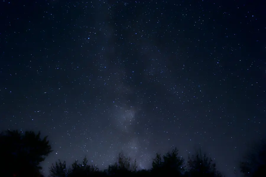 The starry night sky. The milky way is faintly visible.
