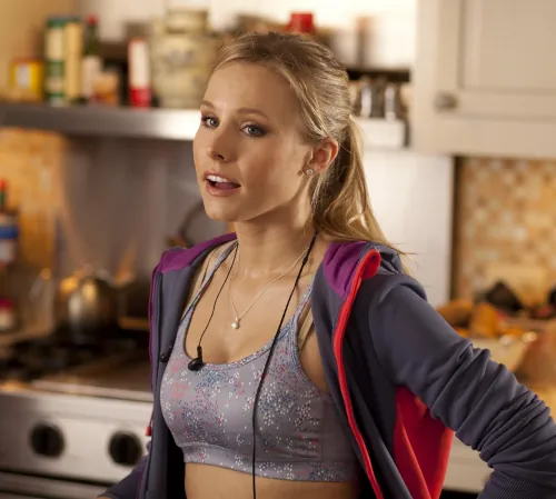 A sporty-looking blonde-haired woman, dressed for working out or jogging.